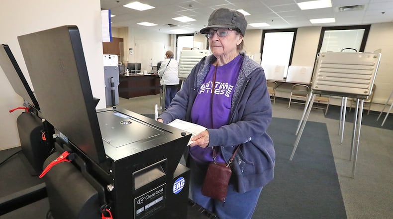 Joy Wohlwend slides her ballot into the voting machine at the Clark County Board of Elections Wednesday, Oct. 12, 2022 during the first day of early voting. BILL LACKEY/STAFF