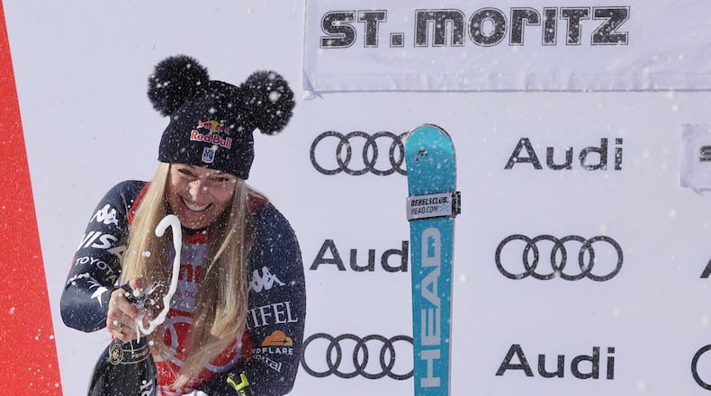 United States' Lindsey Vonn sprays sparkling wine as she celebrates after finishing second in a alpine ski, women's World Cup downhill, in St. Moritz, Switzerland, Saturday Dec. 13, 2025. (AP Photo/Luciano Bisi)