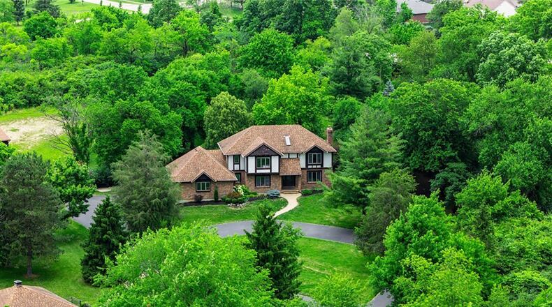 The Tudor style two story features 4 bedrooms and 4,180 finished square feet. It sits on three parcels totaling more than seven acres. CONTRIBUTED