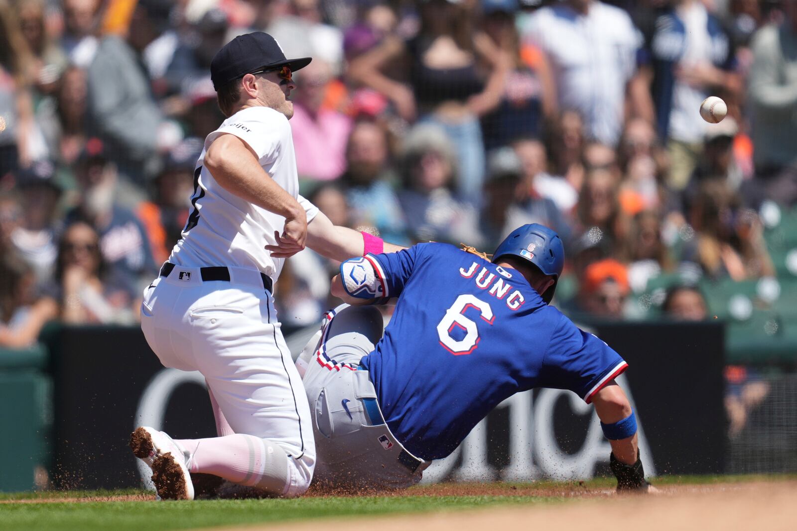 Texas Rangers' Josh Jung (6) slides safely into third base as Detroit Tigers third baseman Jace Jung, left, can't handle the throw in the second inning during a baseball game, Sunday, May 11, 2025, in Detroit. (AP Photo/Paul Sancya)