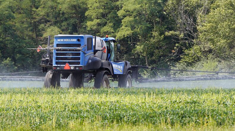 A farmer in Greene County sprays a soybean field along Jasper Road near Jamestown. TY GREENLEES / STAFF