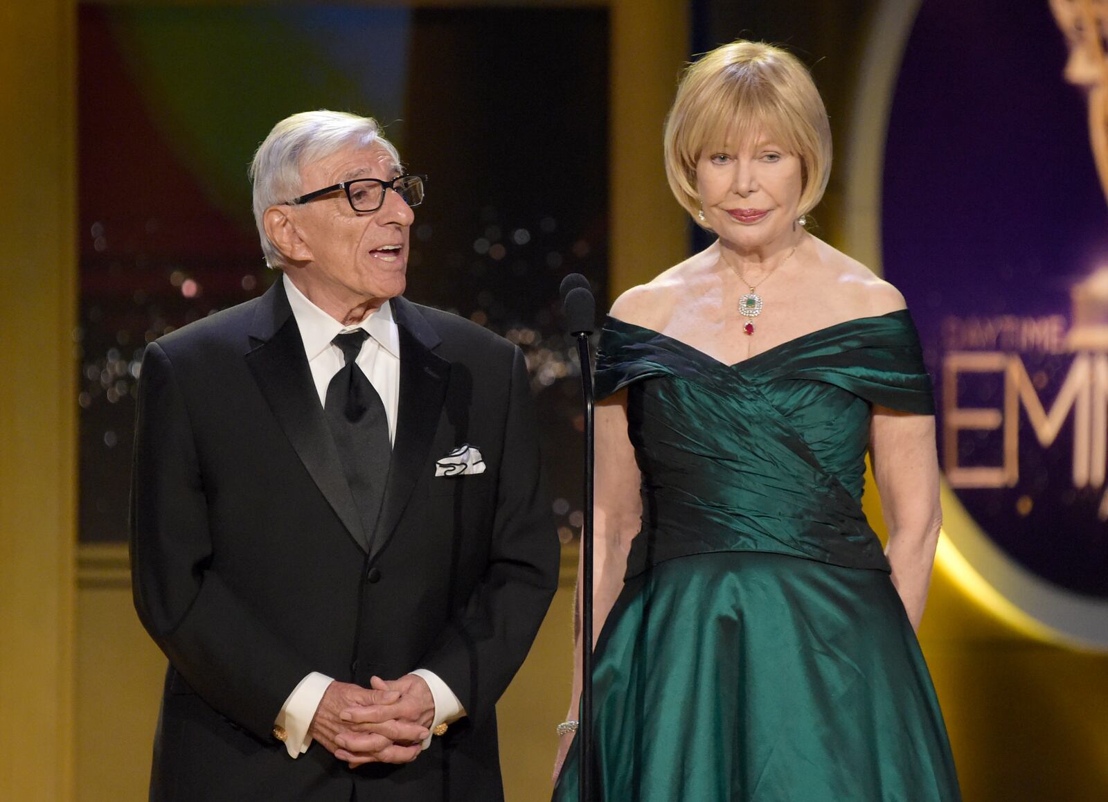 FILE - Jamie Farr, left, and Loretta Swit present a tribute to "Mr. Rogers" at the 45th annual Daytime Emmy Awards on April 29, 2018, in Pasadena, Calif. (Photo by Richard Shotwell/Invision/AP, File
