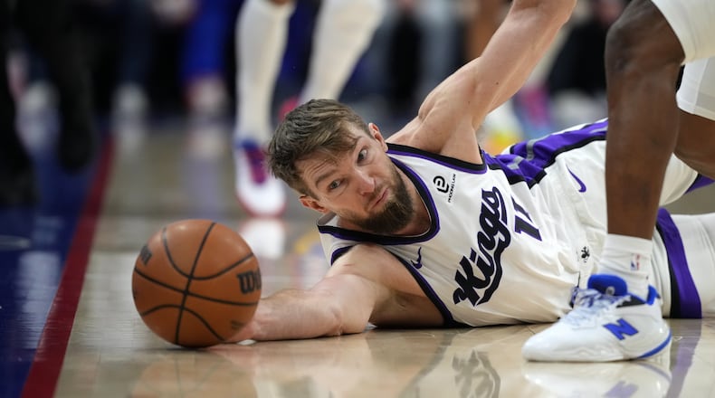 Sacramento Kings' Domantas Sabonis tries to save a lose ball during the first half of an NBA basketball game against the Philadelphia 76ers Thursday, Jan. 29, 2026, in Philadelphia. (AP Photo/Matt Slocum)