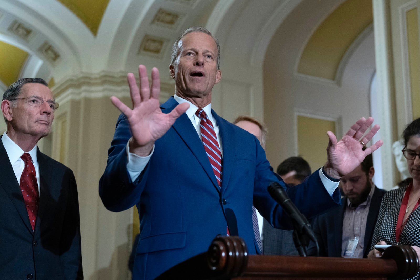 Senate Majority Leader John Thune, R-S.D., flanked by Sen. John Barrasso, R-Wyo., left, to reporters following weekly policy luncheons on Capitol Hill in Washington, Tuesday, May 13, 2025. (AP Photo/Jose Luis Magana)