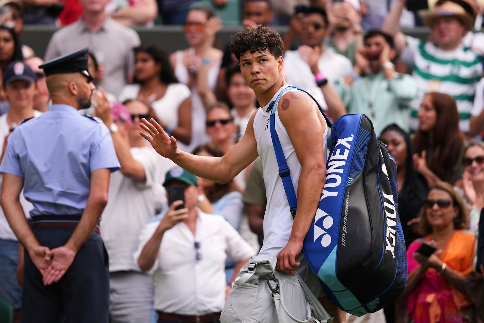 Ben Shelton of the U.S. leaves court after losing the men's singles quarter final match against Jannik Sinner of Italy at the Wimbledon Tennis Championships in London, Wednesday, July 9, 2025.(AP Photo/Kirsty Wigglesworth)
