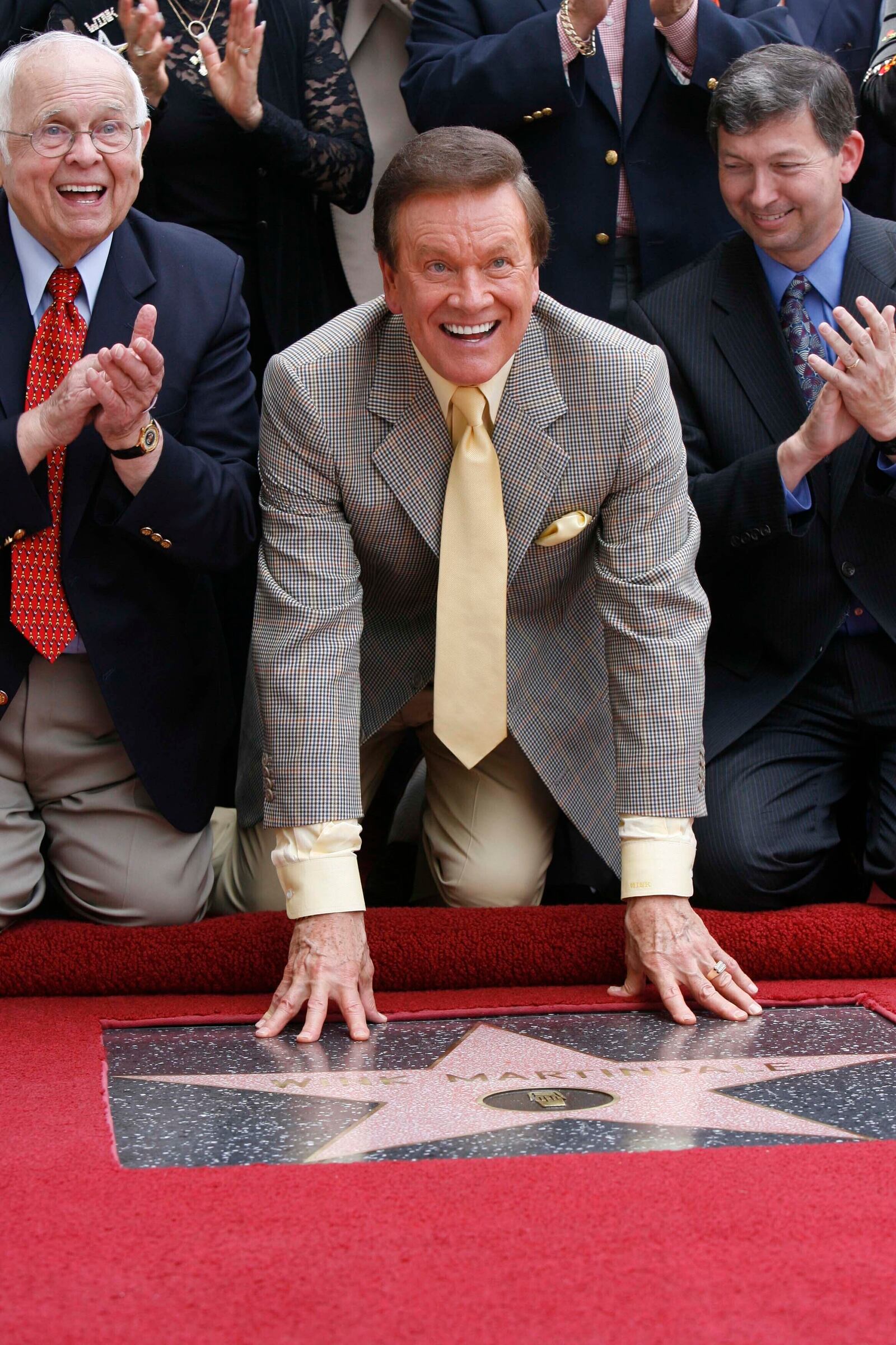 FILE - Game show host Wink Martindale smiles for media and supporters after being honored with a star on the Hollywood Walk of Fame, June 2, 2006, in the Hollywood section of Los Angeles. (AP Photo/Nick Ut, File)