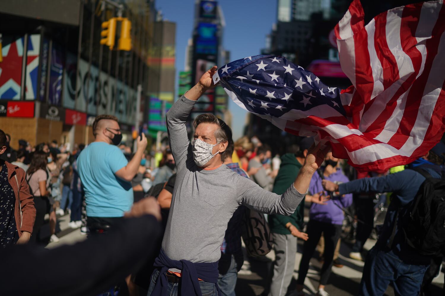 People celebrate after it was announced that Joe Biden was elected the 46th president of the United States, on Saturday, Nov. 7, 2020, in Times Square in New York. President-elect Biden achieved victory offering a message of healing and unity. He will return to Washington facing a daunting set of crises. (Chang W. Lee/The New York Times)