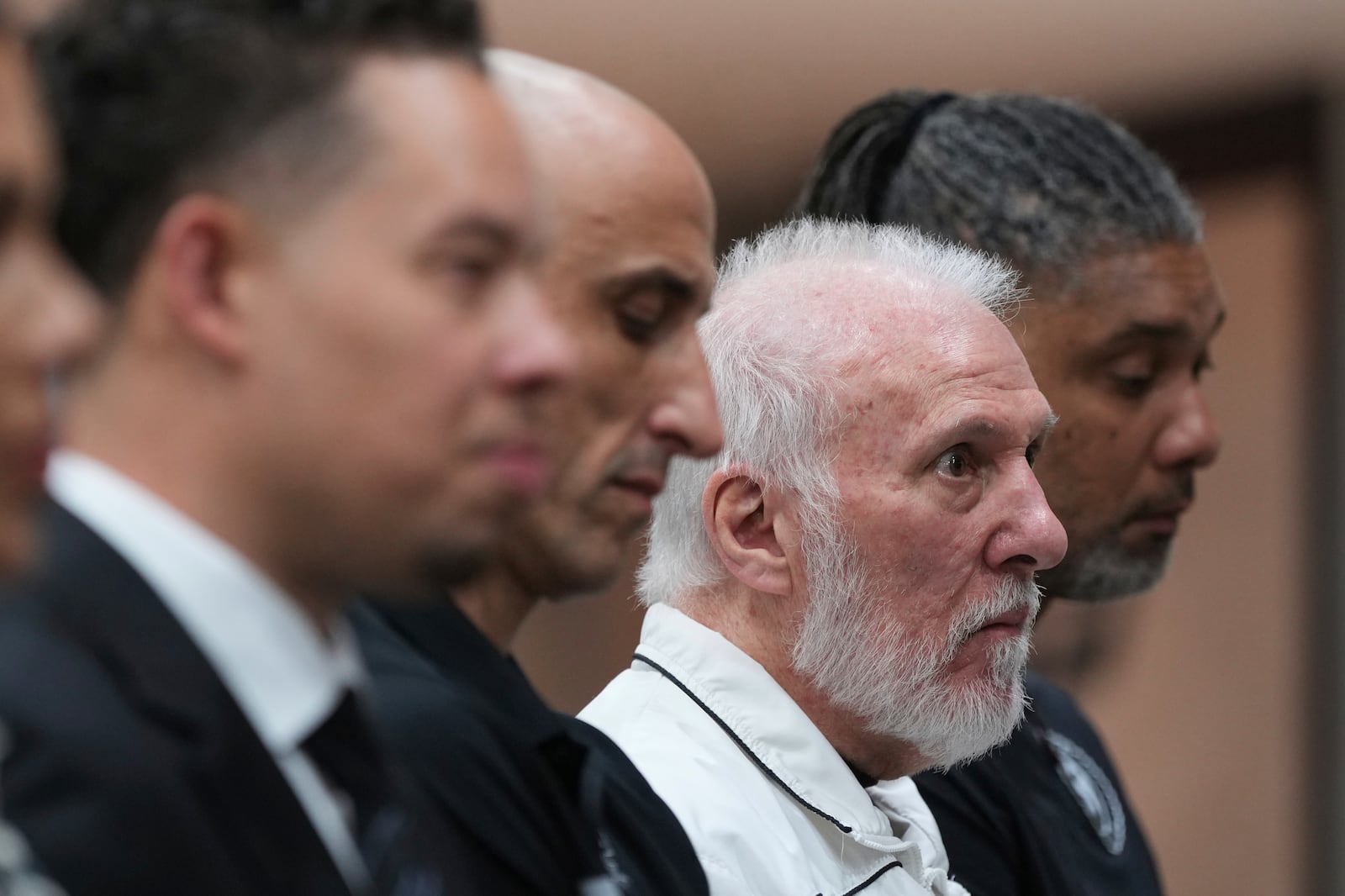 Former San Antonio Spurs head coach Gregg Popovich, second from right, sits between former players Manu Ginobili and Tim Duncan, right, as he waits to introduce Mitch Johnson, left, as the new head coach of the San Antonio Spurs NBA basketball team, in San Antonio, Monday, May 5, 2025. (AP Photo/Eric Gay)