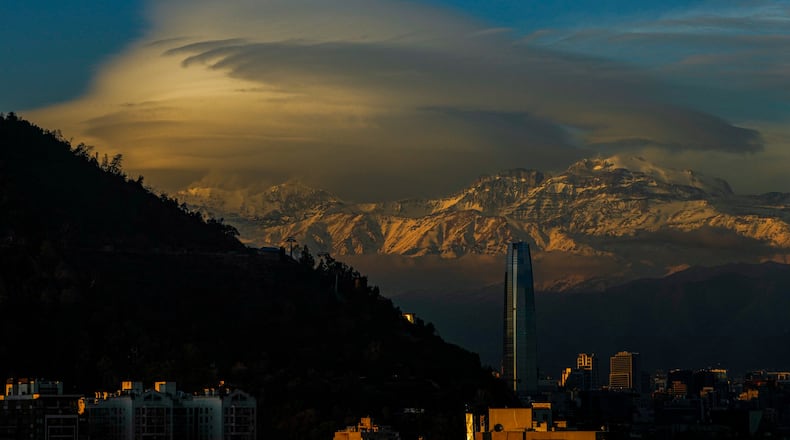 FILE - Clouds hover over the Andes Mountains in Santiago, Chile, June 19, 2024. (AP Photo/Esteban Felix, File)