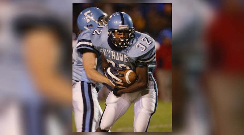 Fairborn's Josh Copeland (32) takes the handoff from quarterback Nico Yantko in during their game against Carroll High School in 2005. RON ALVEY/STAFF PHOTO