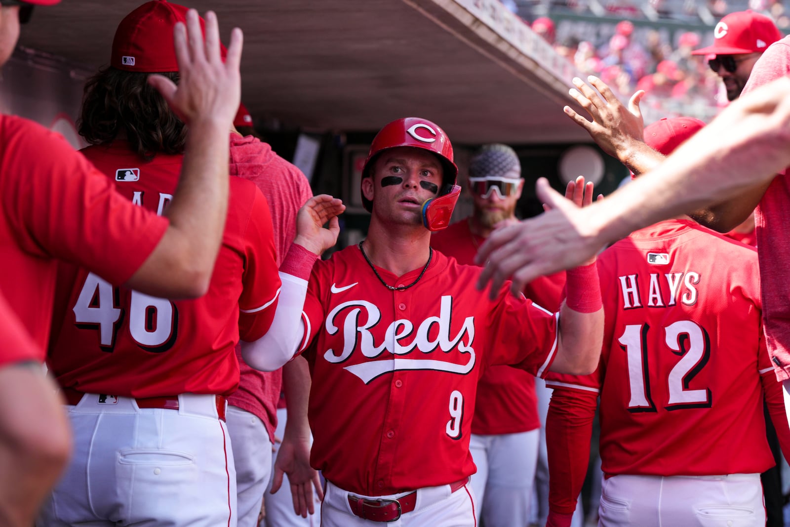 Cincinnati Reds' Matt McLain (9) celebrates with teammates after scoring on a single hit by Gavin Lux during the first inning of a baseball game against the San Diego Padres, Saturday, June 28, 2025, in Cincinnati. (AP Photo/Jeff Dean)