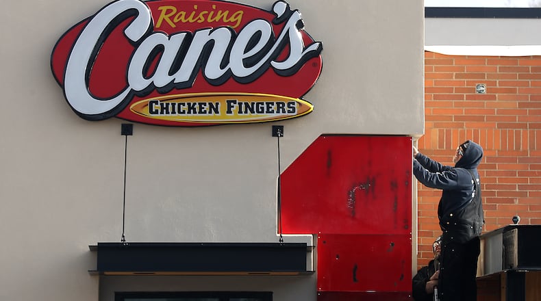 A man works on construction at Raising Cane's Chicken Fingers in January. The restaurant will open on Feb. 15. BILL LACKEY/STAFF