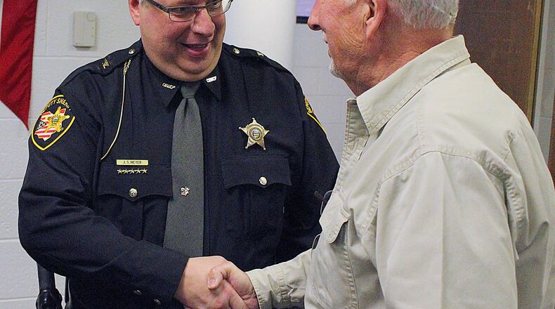 A well wisher congratulates new Clark County Chief Deputy Jeffrey Meyer after he was sworn in Monday. JEFF GUERINI/STAFF