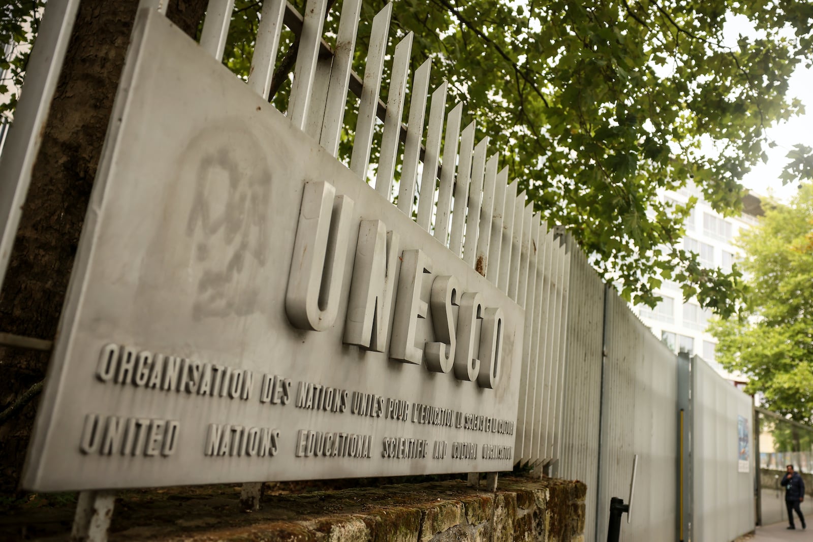 A man enters the UNESCO headquarters Tuesday, July 22, 2025 in Paris. (AP Photo/Thomas Padilla)