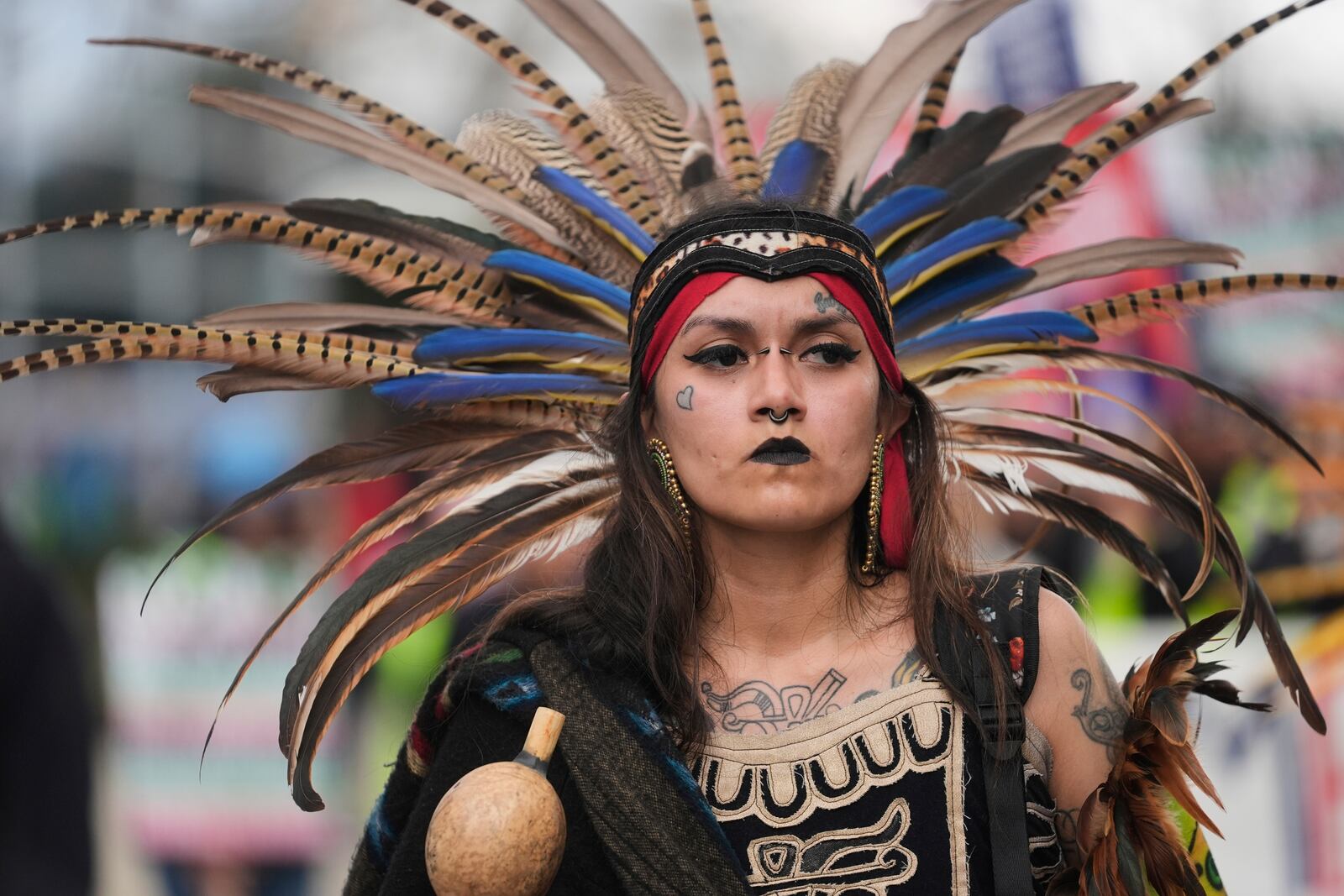 Jasmine Flores wears indigenous Mexican clothing as she and thousands of people march in a May Day rally and protest Thursday, May 1, 2025, in Chicago. (AP Photo/Erin Hooley)