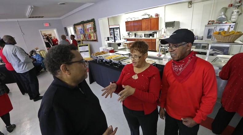 Bonita Mills and her husband, James, talk to Daniel Smith during the open house Wednesday to celebrate the 65th anniversary of Family Needs, Inc. Bonita’s parents started Family Needs out of their own house. BILL LACKEY/STAFF