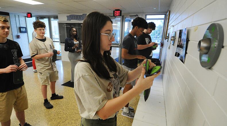 Fairborn High School students place their cell phones into pouches Thursday, May 23, 2024. Front row, left to right, Isabelle Fischer, Andrew Wilson and Travis Butts, back row from left Shane Walden, Clayton Finlay and Aita Samb. MARSHALL GORBY\STAFF