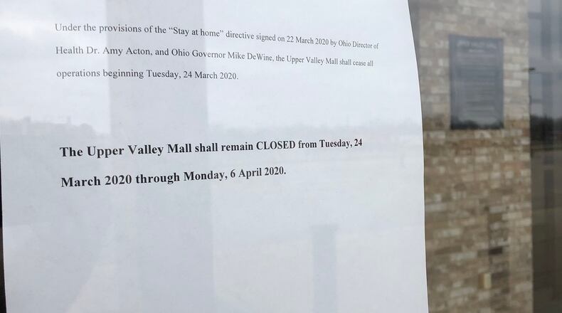 The sign on the door at the Upper Valley Mall explains why they are closed through Monday, April 6 due to the stay-at-home order. BILL LACKEY/STAFF