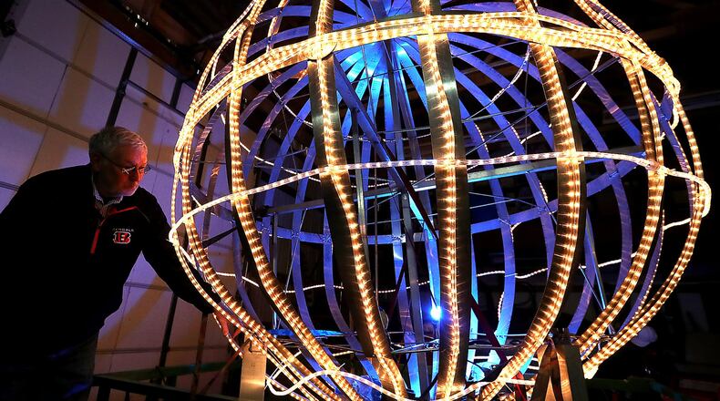 Jim Bobo gets to illuminated ball ready Monday for the 10th annual New Carlisle New Year’s Eve Ball Drop to ring in the new year Tuesday evening. Besides the ball drop, there will also be ice sculptures, carriage rides, 50/50 drawing and free giveaways. BILL LACKEY/STAFF