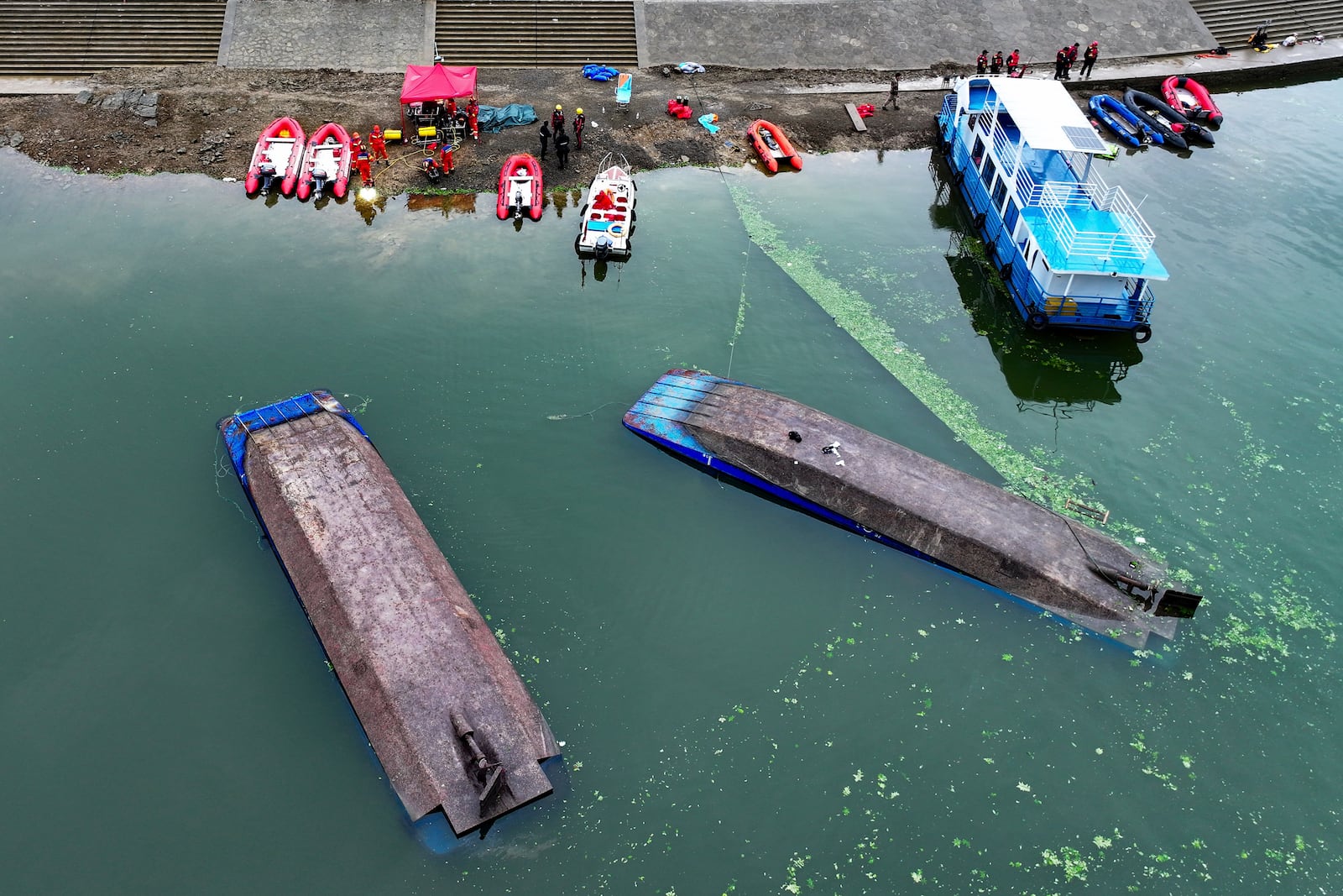 This photo released by Xinhua News Agency shows rescuers carrying out search and rescue operation at the site showing the two passenger boats capsized in Qianxi City, southwest China's Guizhou Province on Monday, May 5, 2025. (Liu Xu/Xinhua via AP)