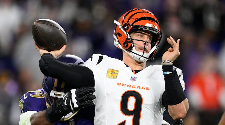 Baltimore Ravens linebacker Odafe Oweh, left, pressures Cincinnati Bengals quarterback Joe Burrow (9) as he passes the ball during the first half of an NFL football game, Thursday, Nov. 7, 2024, in Baltimore. (AP Photo/Nick Wass)