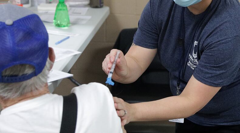 A patient gets their COVID vaccine shot at the Clark County Health District's vaccine center. BILL LACKEY/STAFF