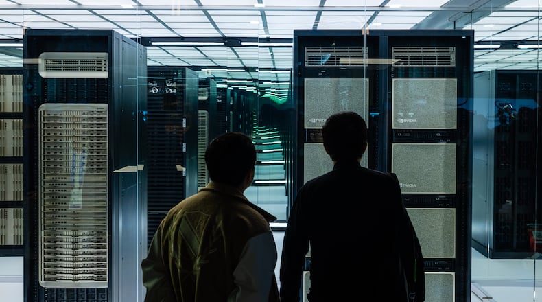 Attendees look at a display during the Nvidia GTC conference in Washington, on Tuesday, Oct. 28, 2025. Spending on data centers, which are filled with Nvidia chips, was a driving force behind the U.S. economic growth this year. (Eric Lee/The New York Times)