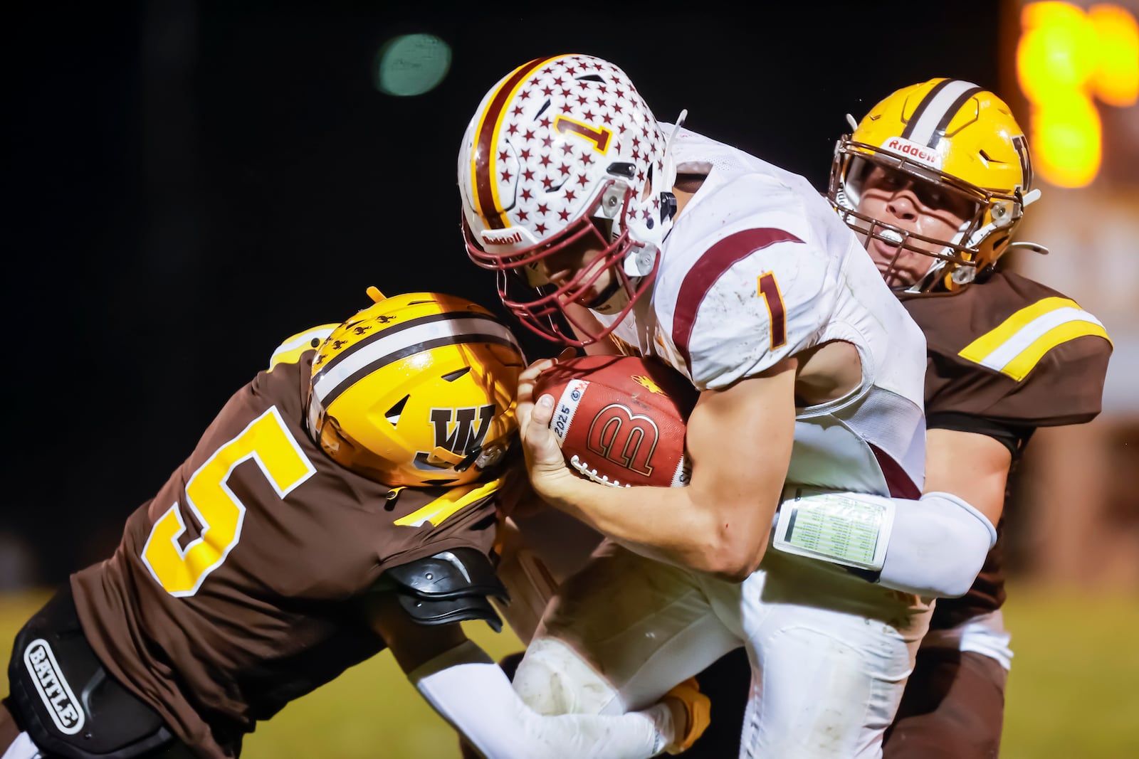 Northeastern High School senior Cody Houseman is hit by West Jefferson junior Xavier Counts during their game on Friday, Sept. 26 at Kile Field. The Roughriders won 42-36 in overtime. MICHAEL COOPER / STAFF