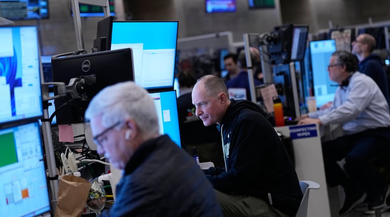 Traders work on the floor at the New York Stock Exchange in New York, Friday, Jan. 9, 2026. (AP Photo/Seth Wenig)