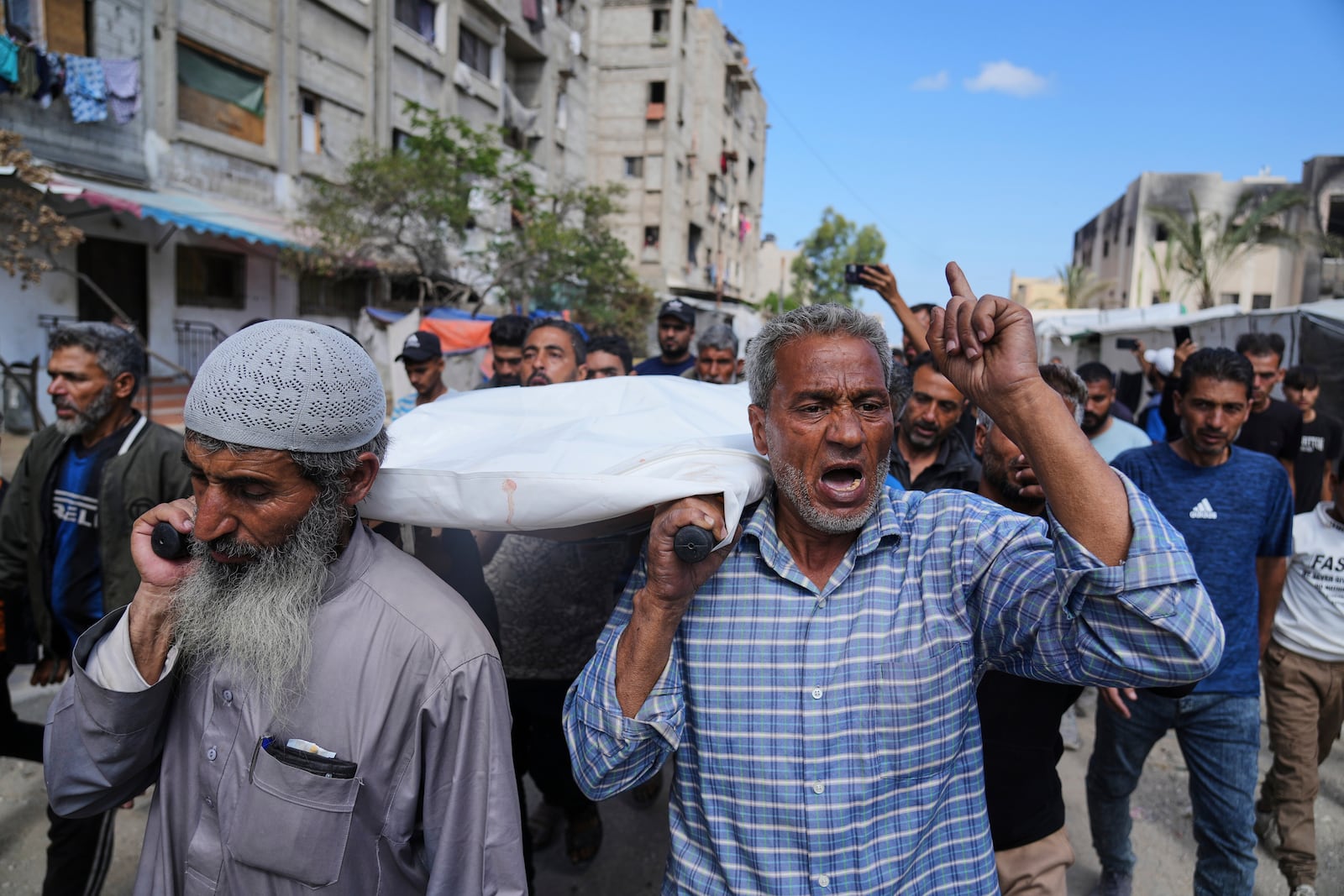 Palestinians carry Reem Al-Akhras, who was killed while heading to an aid distribution hub, during her funeral in Khan Younis, Gaza Strip, Tuesday, June 3, 2025. (AP Photo/Abdel Kareem Hana)