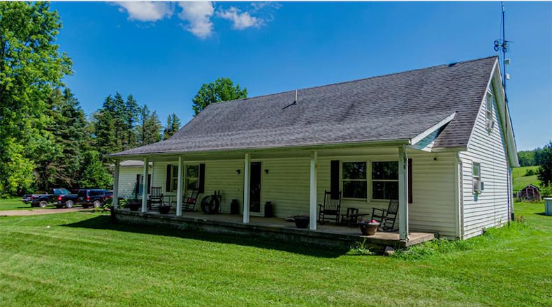 The vinyl-sided home has a full covered front porch with pillars and a side-entry, two-car garage. Contributed photos
