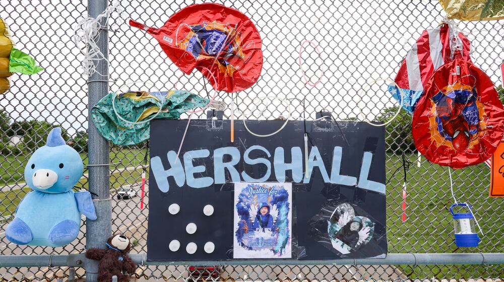 A memorial has been set up on the McClure Street bridge over U.S. 35 for Hershall Creachbaum, a 7-year-old who was found dead on July 12, 2025. Balloons, stuffed animals and signs are among items people have left. BRYANT BILLING / STAFF