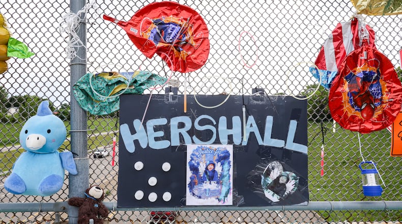 A memorial has been set up on the McClure Street bridge over U.S. 35 for Hershall Creachbaum, a 7-year-old who was found dead on July 12, 2025. Balloons, stuffed animals and signs are among items people have left. BRYANT BILLING / STAFF