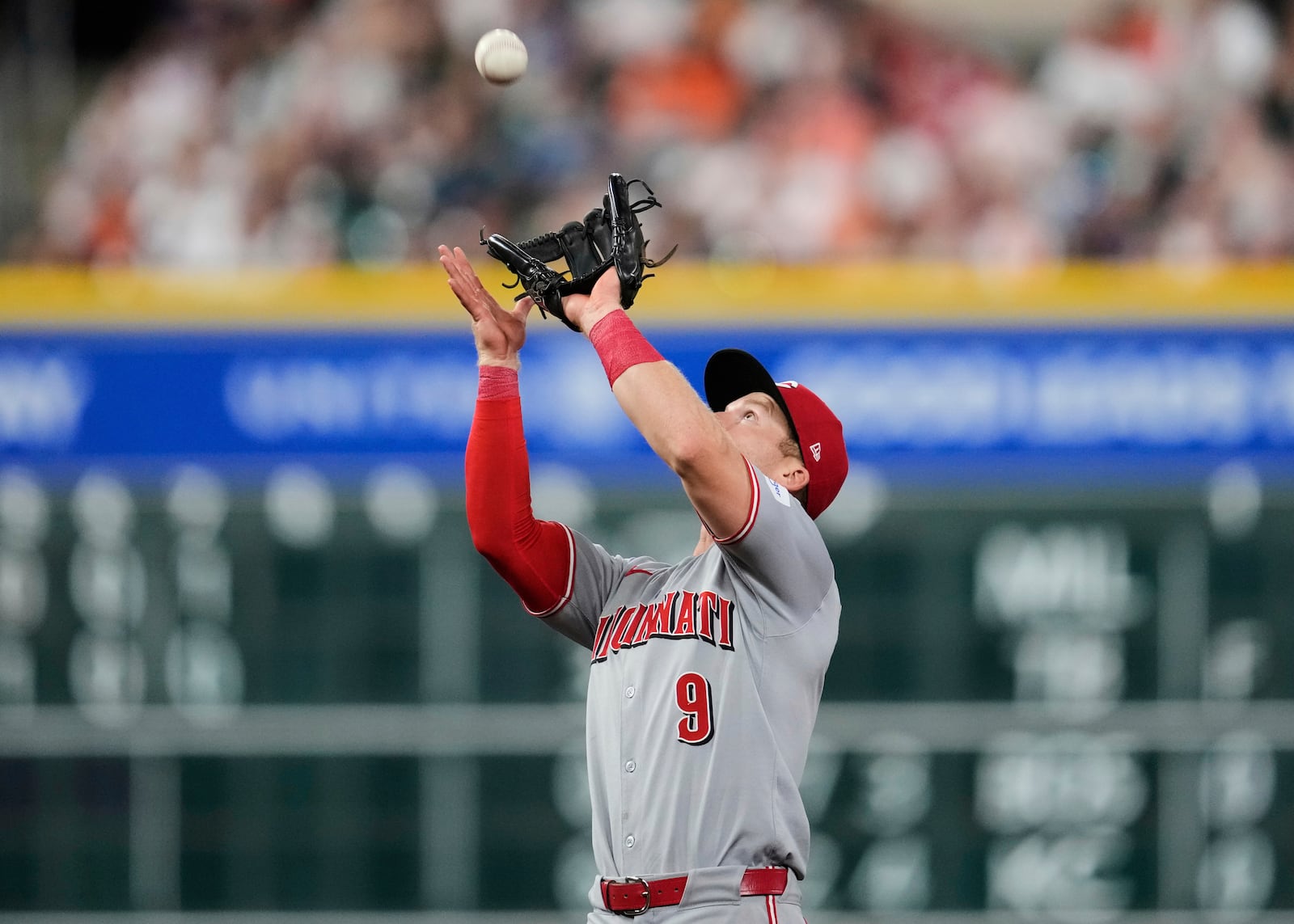 Cincinnati Reds second baseman Matt McLain catches a fly ball hit by Houston Astros' Jose Altuve during the seventh inning of a baseball game in Houston, Friday, May 9, 2025. (AP Photo/Ashley Landis)