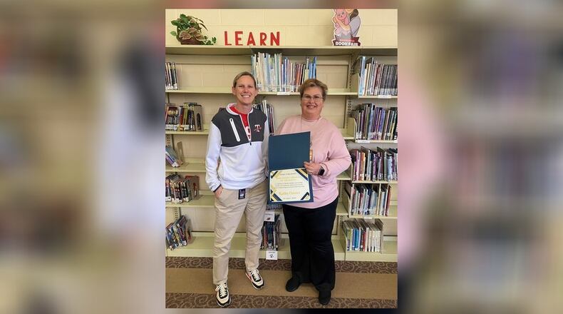 Kathleen Oaster (right), library media specialist at Tecumseh Middle School, is the recipient of the Rosen Publishing Ohio School Librarian of the Month Award for October 2024. She is pictured with school principal Lauren McFarland. Contributed