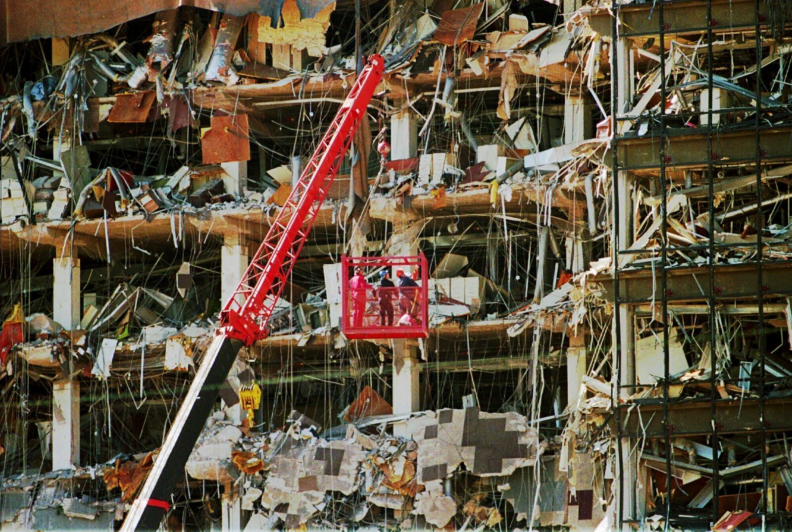 FILE - Rescue workers dig through the rubble from the Alfred P. Murrah Federal Building explosion in downtown Oklahoma City on April 20, 1995. (AP Photo/J.Pat Carter, File)