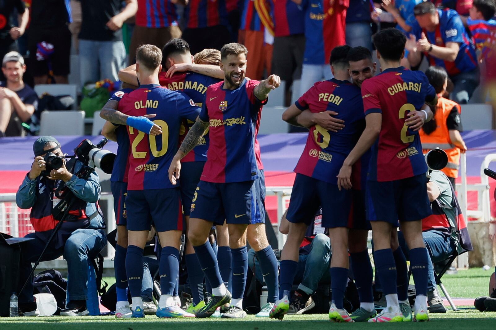 Barcelona players celebrate after a goal during the La Liga soccer match between Barcelona and Real Madrid in Barcelona, Spain, Sunday, May 11, 2025. AP Photo/Joan Monfort)