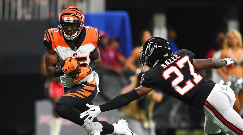 ATLANTA, GA - SEPTEMBER 30: John Ross #15 of the Cincinnati Bengals breaks a tackle by Damontae Kazee #27 of the Atlanta Falcons en route to a touchdown during the second quarter at Mercedes-Benz Stadium on September 30, 2018 in Atlanta, Georgia. (Photo by Scott Cunningham/Getty Images)