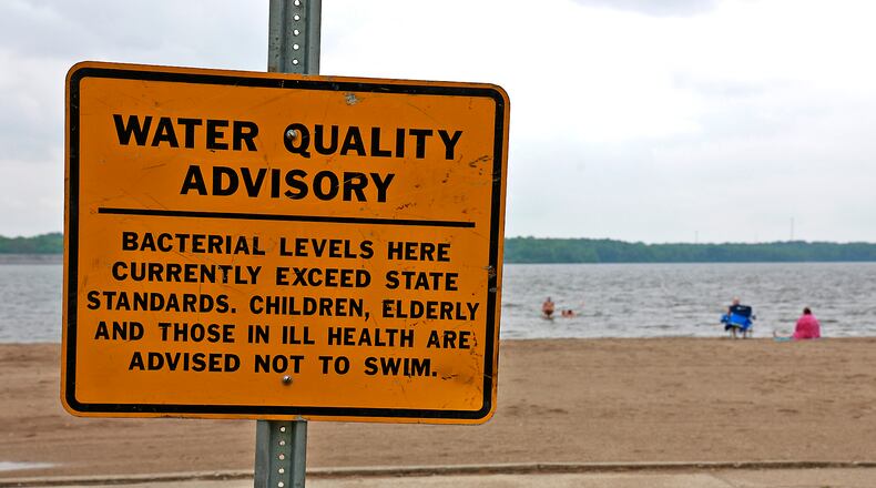 Water Quality Advisory signs have been posted on the beach at Buck Creek State Park Friday, June 16, 2023. BILL LACKEY/STAFF