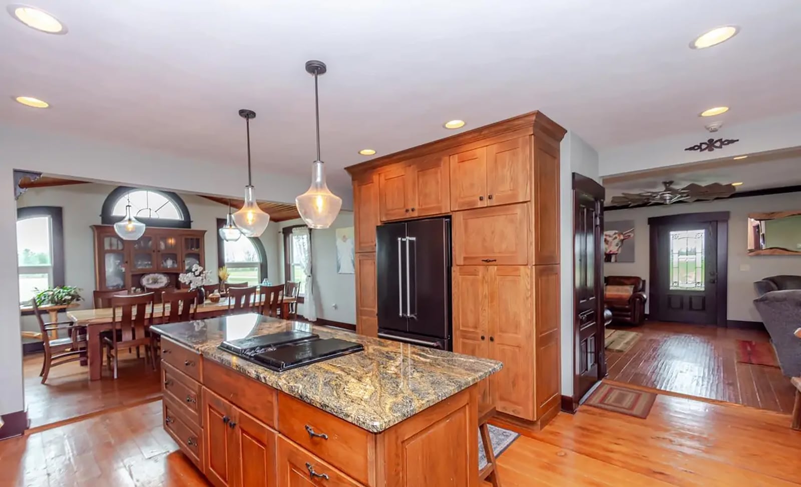 The eat in kitchen has hardwood floors, an island with bar seating, granite countertops and updated appliances. CONTRIBUTED