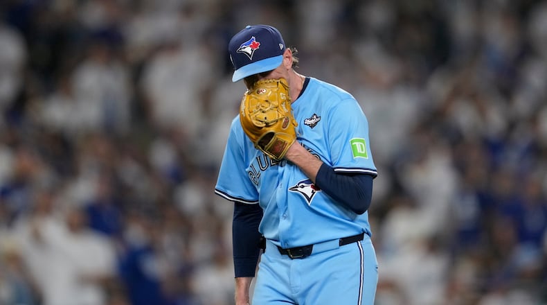 Toronto Blue Jays' pitcher Shane Bieber yells in his glove as he leaves the game during the sixth inning in Game 4 of baseball's World Series against the Los Angeles Dodgers, Tuesday, Oct. 28, 2025, in Los Angeles. (AP Photo/Ashley Landis)