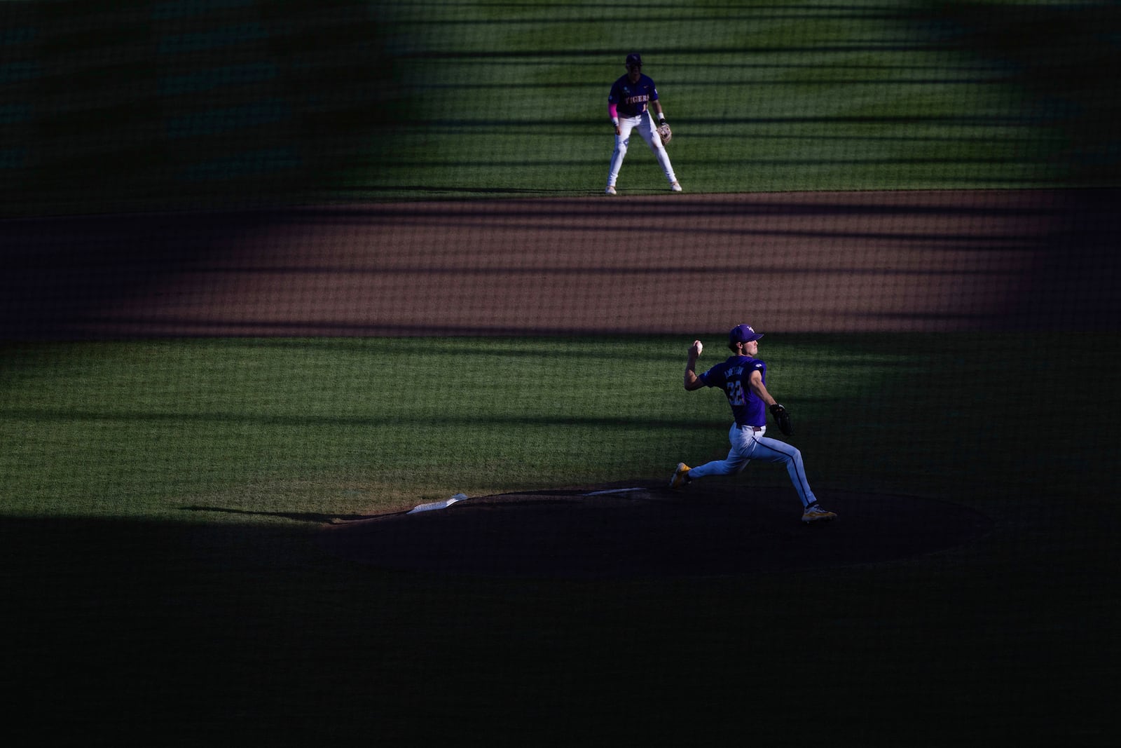 FILE - LSU starting pitcher Kade Anderson, bottom, throws against Coastal Carolina in the fourth inning of Game 1 of the NCAA College World Series baseball finals in Omaha, Neb., June 21, 2025. (AP Photo/Rebecca S. Gratz, File)