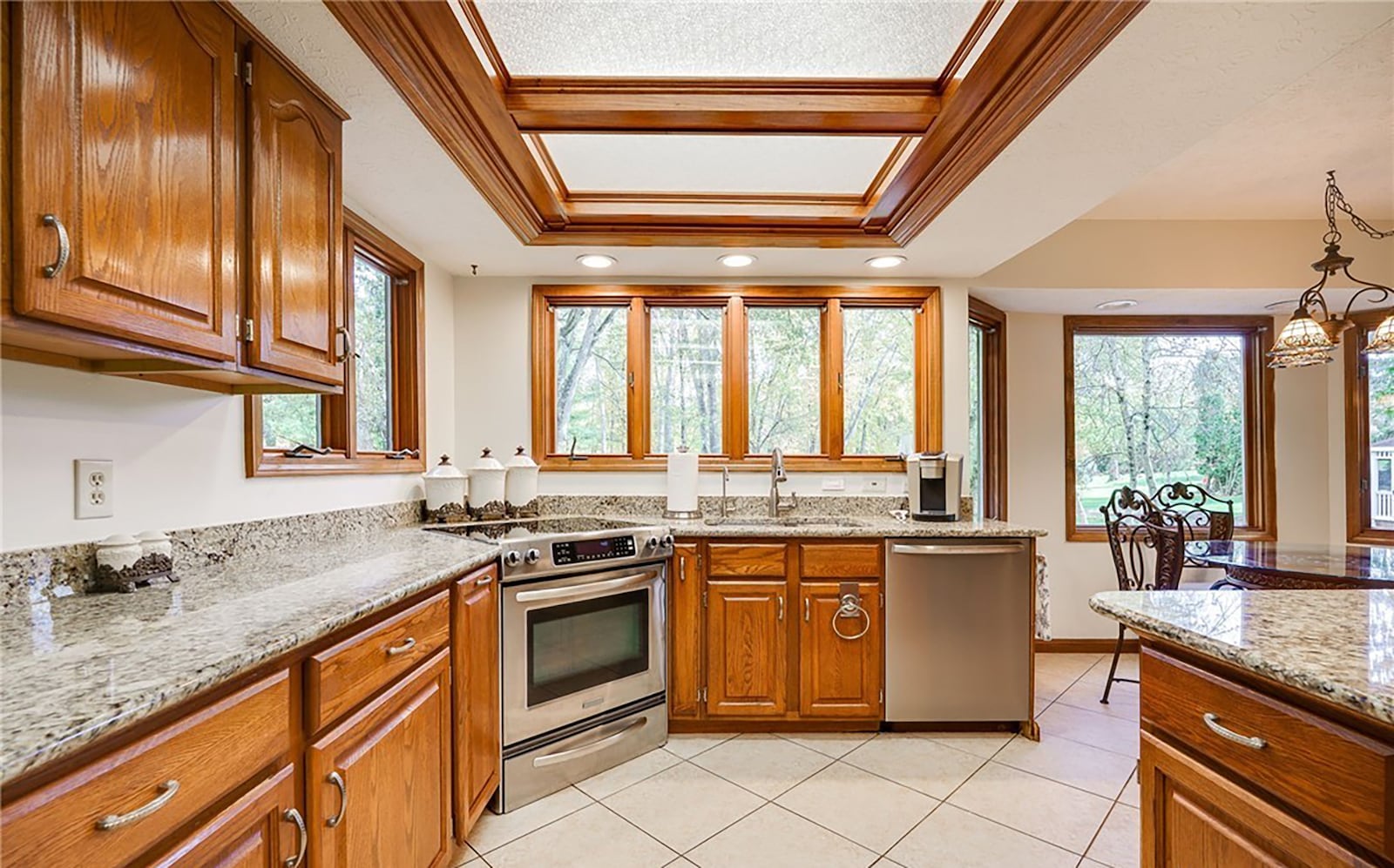 The kitchen and breakfast nook have tile flooring, wood cabinets and granite tops and updated appliances. An exterior door opens to the deck. CONTRIBUTED