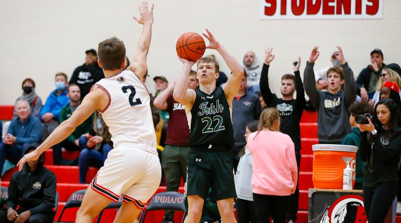 Cutline: Catholic Central High School senior Ian Galluch prepares to shoot the ball over Cedarville's Max Pollander on Jan. 21, 2022. Michael Cooper/CONTRIBUTED