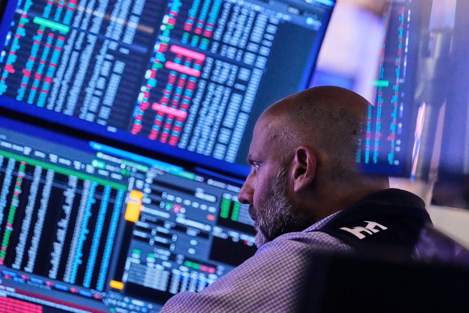 Specialist Meric Greenbaum works at his post on the floor of the New York Stock Exchange, Tuesday, July 8, 2025. (AP Photo/Richard Drew)