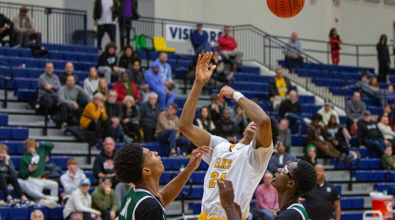 Centerville's Baboucarr Njie is fouled by Isidore Newman's Chris Cenac Jr. with eight seconds left to set up the Elks' winning free throws in a game at Flyin' to the Hoop. Jeff Gilbert/CONTRIBUTED