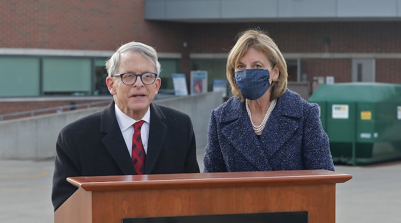 Gov. Mike DeWine with  his wife, Fran, talk to members of the media after the first shipment of COVID-19 vaccine arrived at Springfield Regional Medical Center Tuesday morning. BILL LACKEY/STAFF