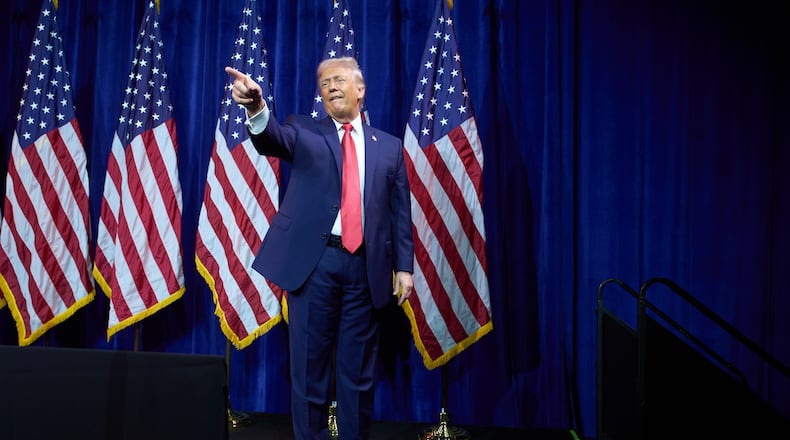 President Donald Trump points to the crowd as he walks off stage after speaking to House Republican lawmakers during their annual policy retreat, Tuesday, Jan. 6, 2026, in Washington. (AP Photo/Evan Vucci)
