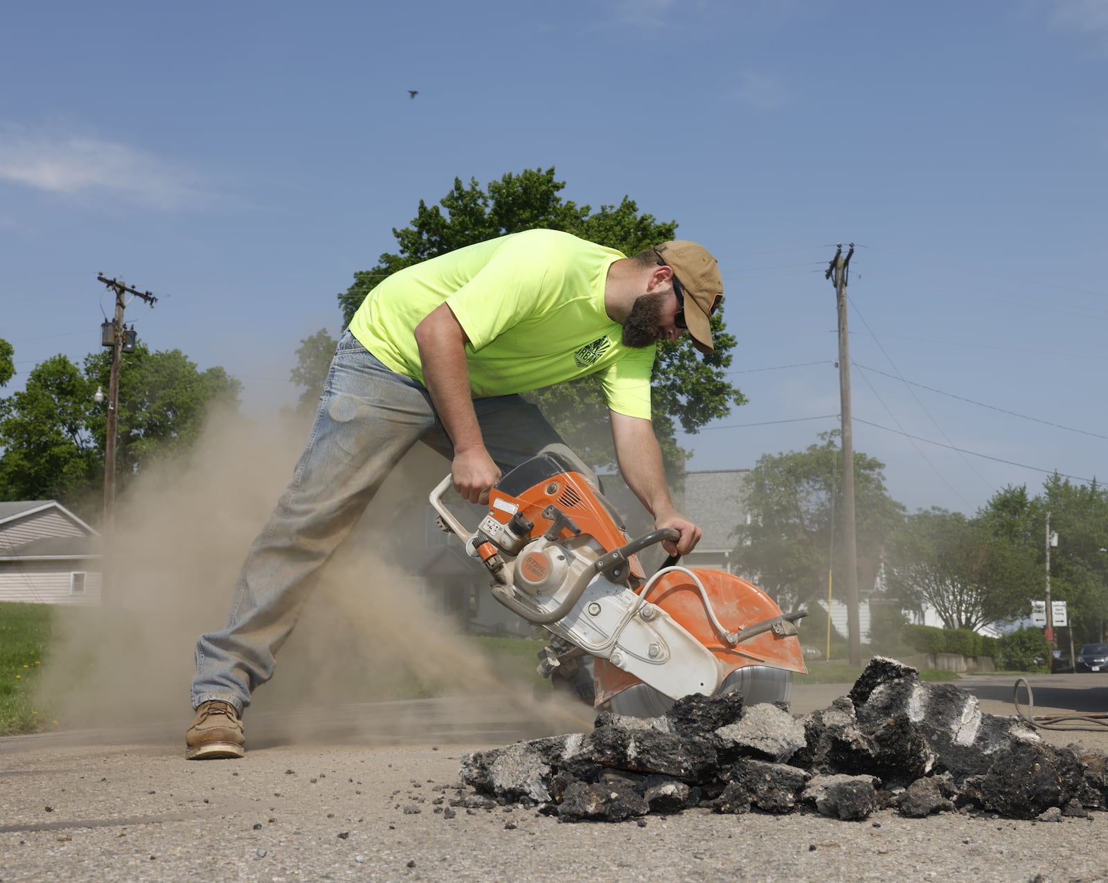 City of Urbana worker Tyler Ohmeiss uses a saw to work on Laurel Oak Street on Thursday, May 15, 2025, in Urbana. JOSEPH COOKE/STAFF