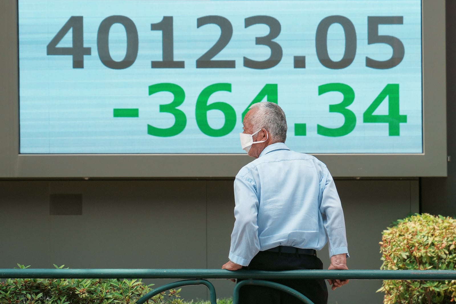 A person looks at an electronic stock board showing Japan's Nikkei index at a securities firm Tuesday, July 1, 2025, in Tokyo. (AP Photo/Eugene Hoshiko)